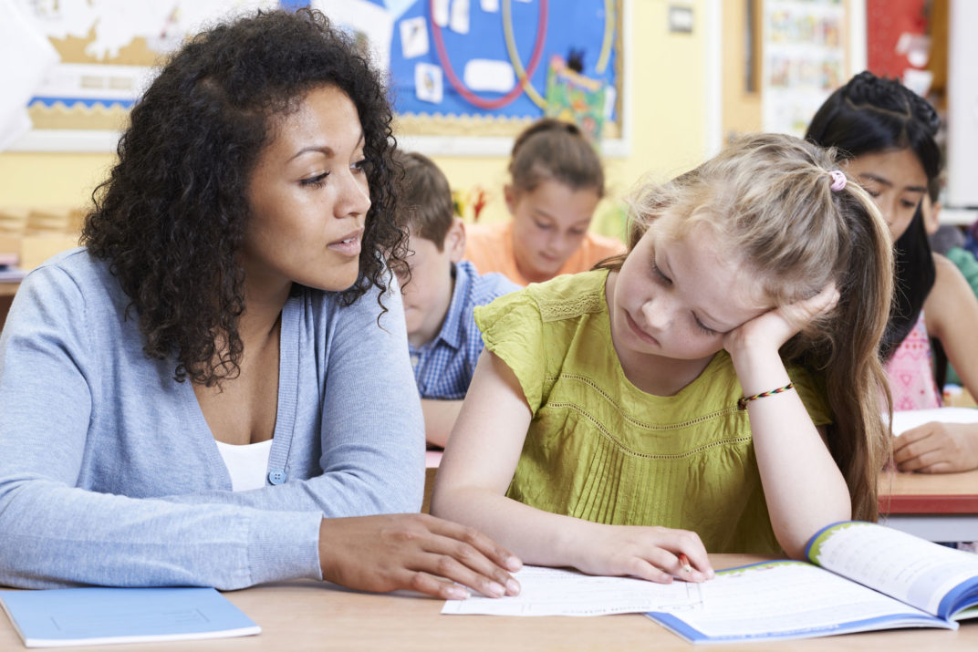 teacher female elementary school pupil with problem