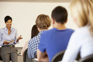 african american teacher teaching at front of class