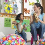 teacher demonstrating tambourine playing