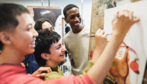 Students painting inside art room class at university; inspiring nonprofits concept