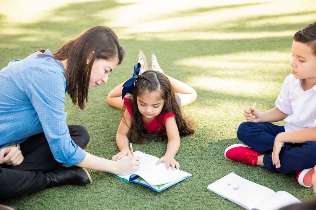 Teacher helping a student with her work