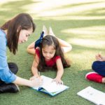 Teacher helping a student with her work