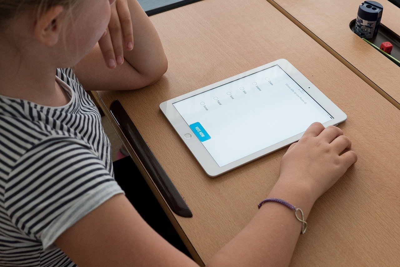 child does schoolwork on tablet; remotely engage young students concept