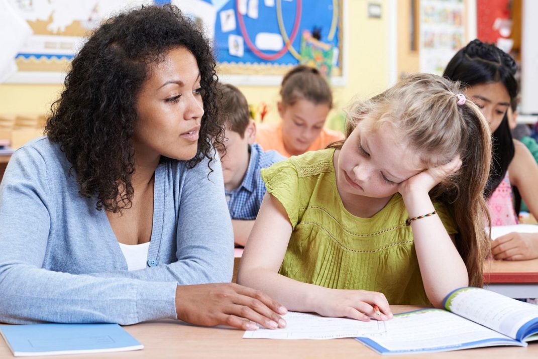 Teacher Female Elementary School Pupil With Problem