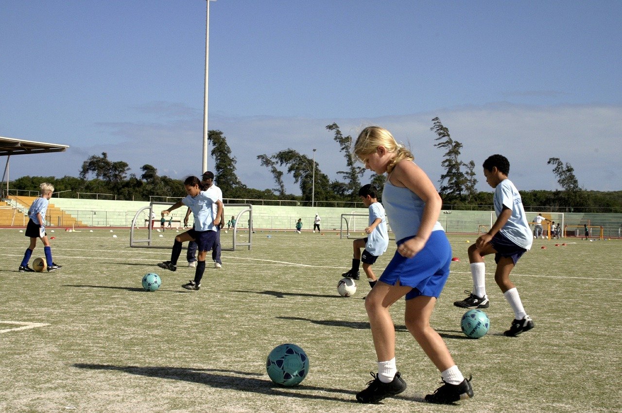 children at soccer practice; return to gym class concept