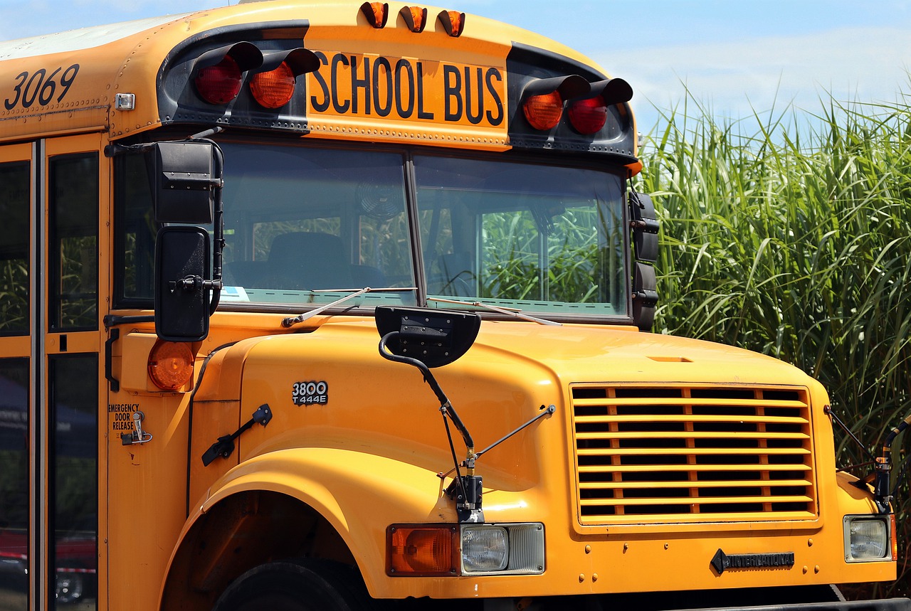a yellow school bus; educators tackle community issues concept