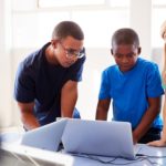 Group Of Students In After School Computer Coding Class Learning To Program Robot Vehicle