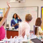 Teacher And Pupils In High School Science Class