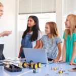 Three Female Students With Teacher Building Robot Vehicle; careers lessons plans concept