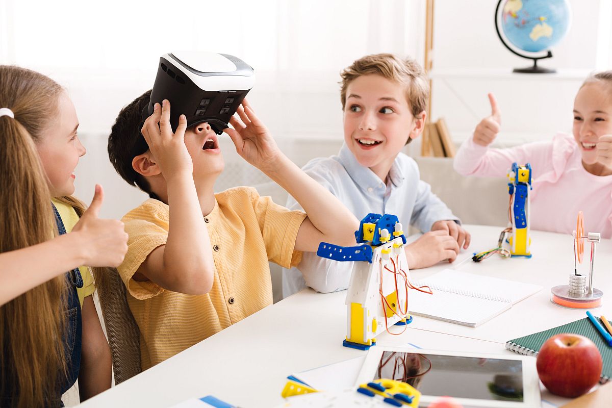 Happy schoolboy using VR glasses; math real-world use concept