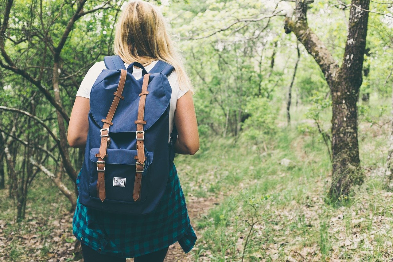 a student hikes in nature; self-care tips for teachers concept