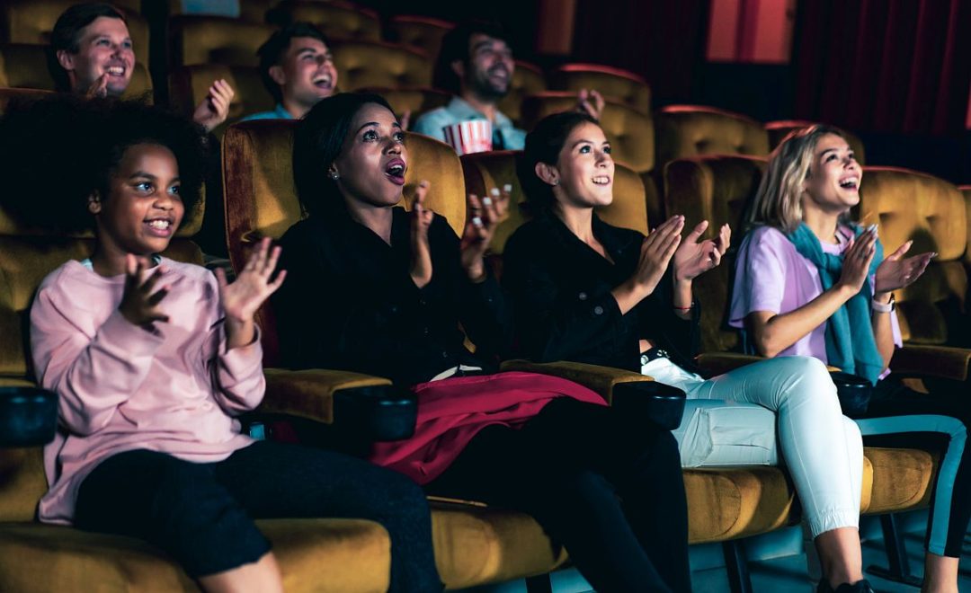 People audience watching movie in the movie theater cinema. Group recreation activity and entertainment concept.