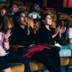 People audience watching movie in the movie theater cinema. Group recreation activity and entertainment concept.