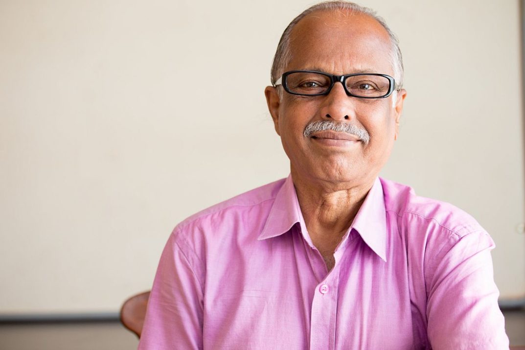 kind teacher in pink shirt in front of a blackboard; teaching in a different state concept