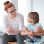 Woman and child sitting together; learning disabilities concept