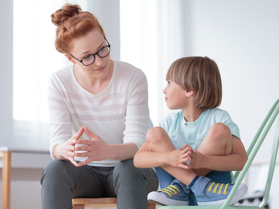 Woman and child sitting together; learning disabilities concept