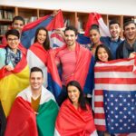 Group of students in classroom, with large flags from different countries; English Language Learners concept