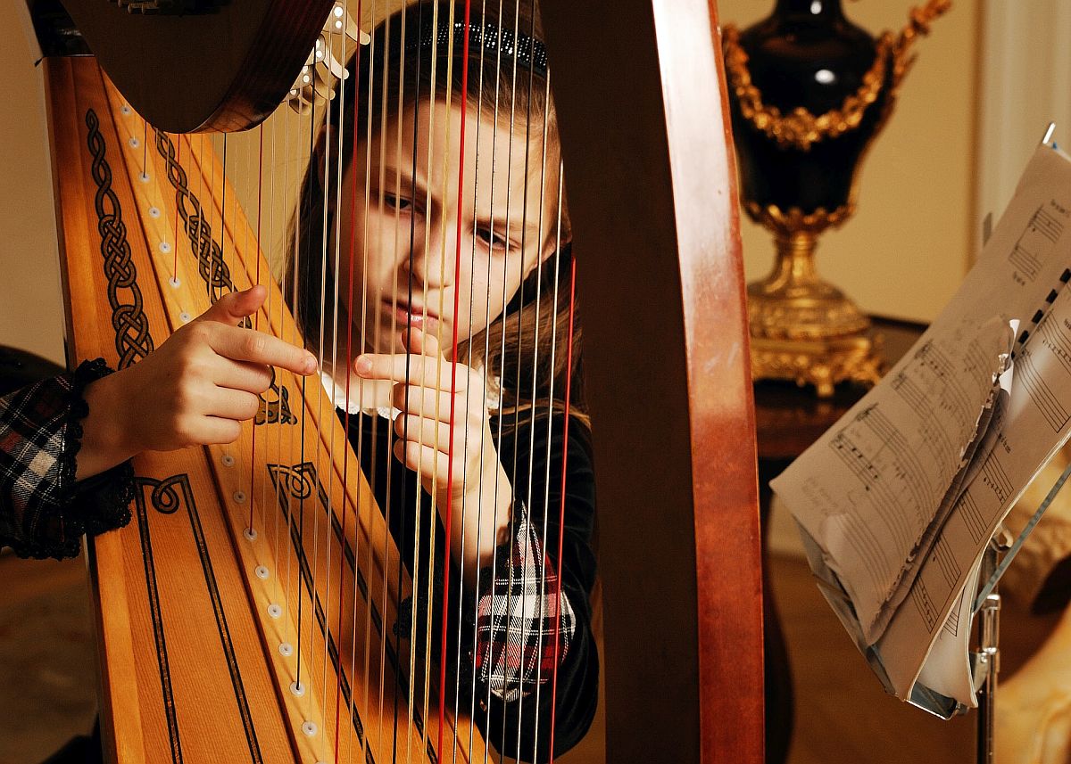 Girl practicing on a harp; improve social emotional skills concept