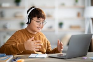 Asian boy schooler having online lesson from home