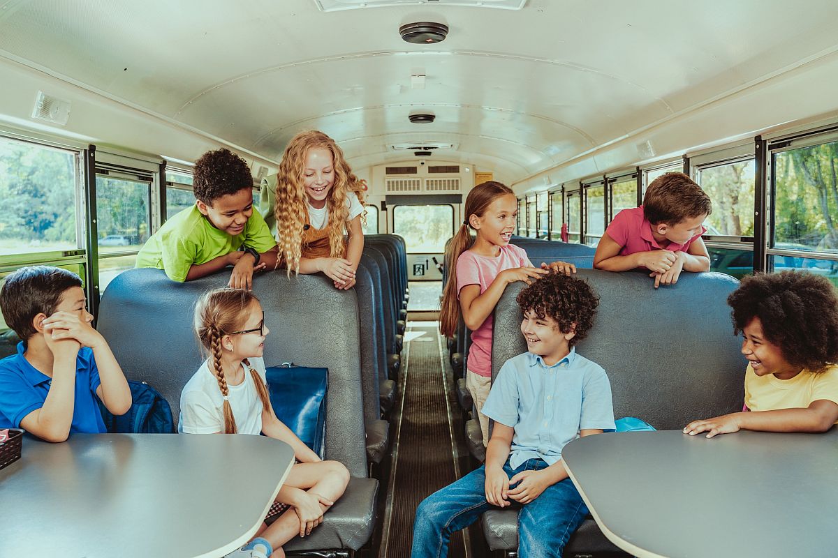 Group of young students on a school bus; community destinations concept