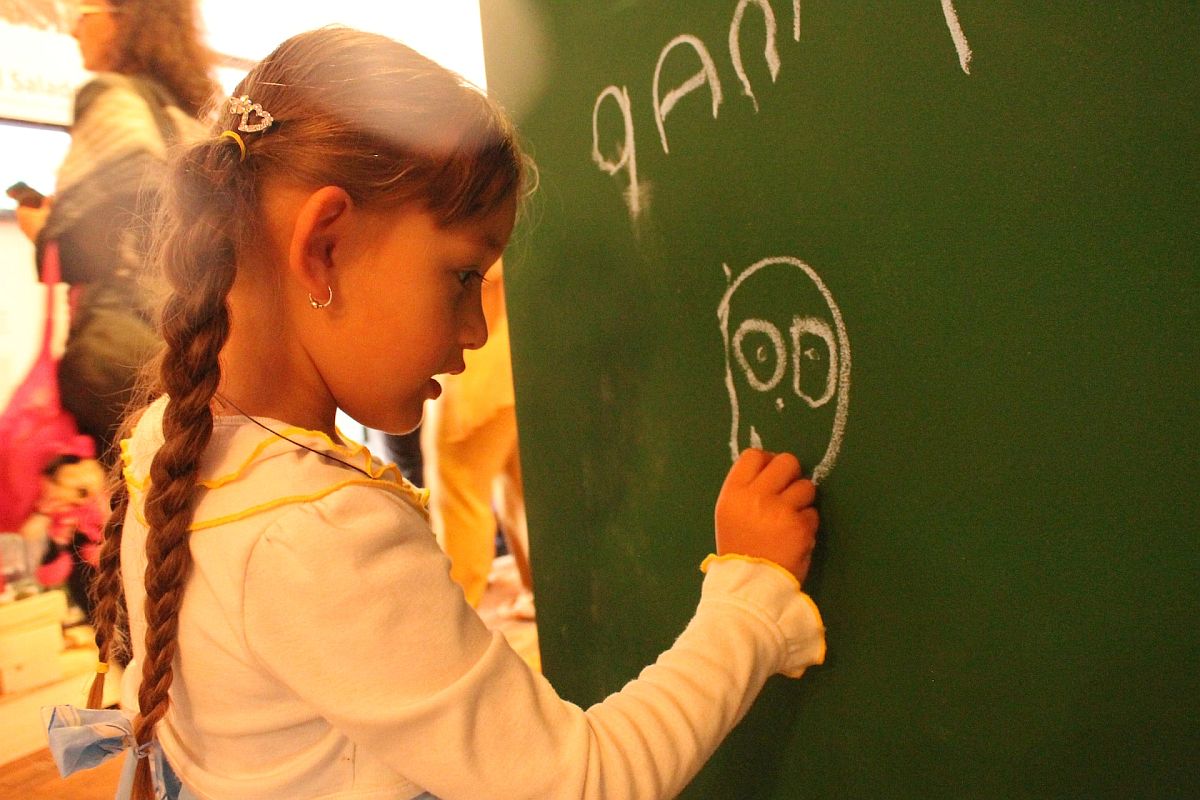 Child at chalkboard; help students with learning disabilities concept