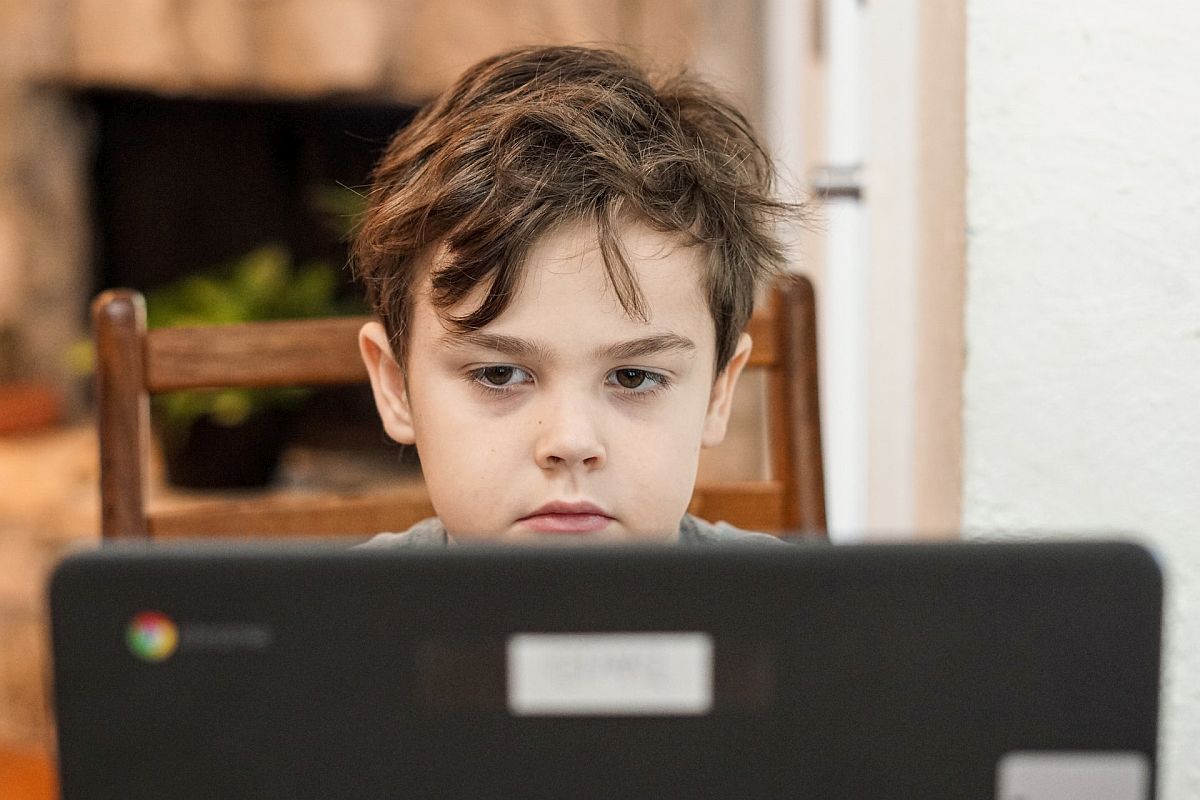 Child in front of computer monitor; find student tutoring concept