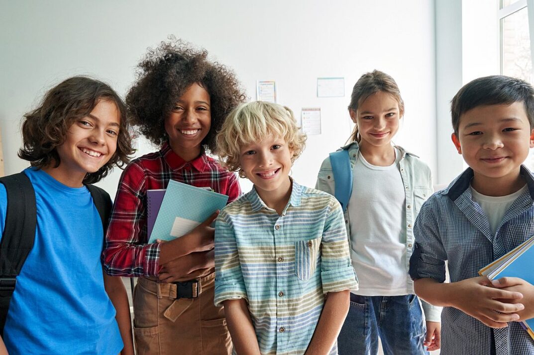 Group of smiling middle school students; holistic learning concept