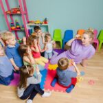 Young students playing numbers games with teacher; make math fun concept