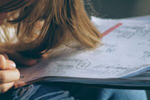 close-up student doing math homework; math specialists concept