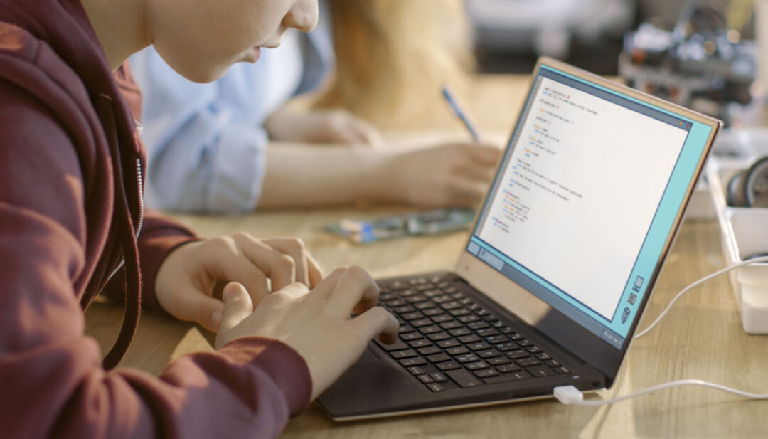 Child using laptop in class; AI-generated content concept