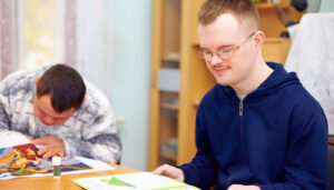 Man studies in library; special education directors concept